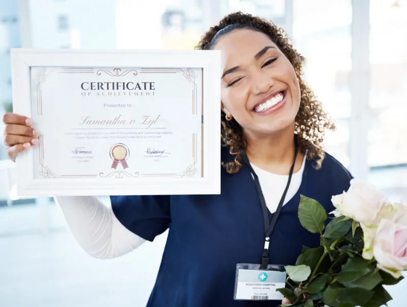 Certificate, flowers and portrait with a black woman graduate or nurse in the hospital, proud of he.